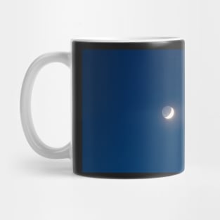 Moon's grey light against blue starry sky background Mug